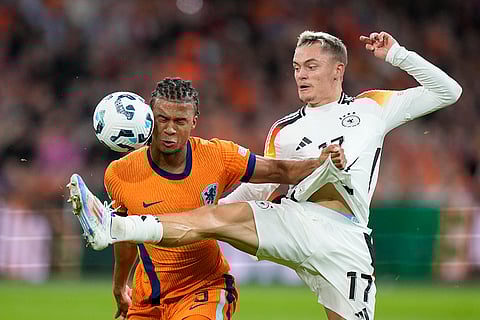 UEFA Nations League, Netherlands vs Germany: Nathan Ake of the Netherlands, left, and Germany's Florian Wirtz fight for the ball